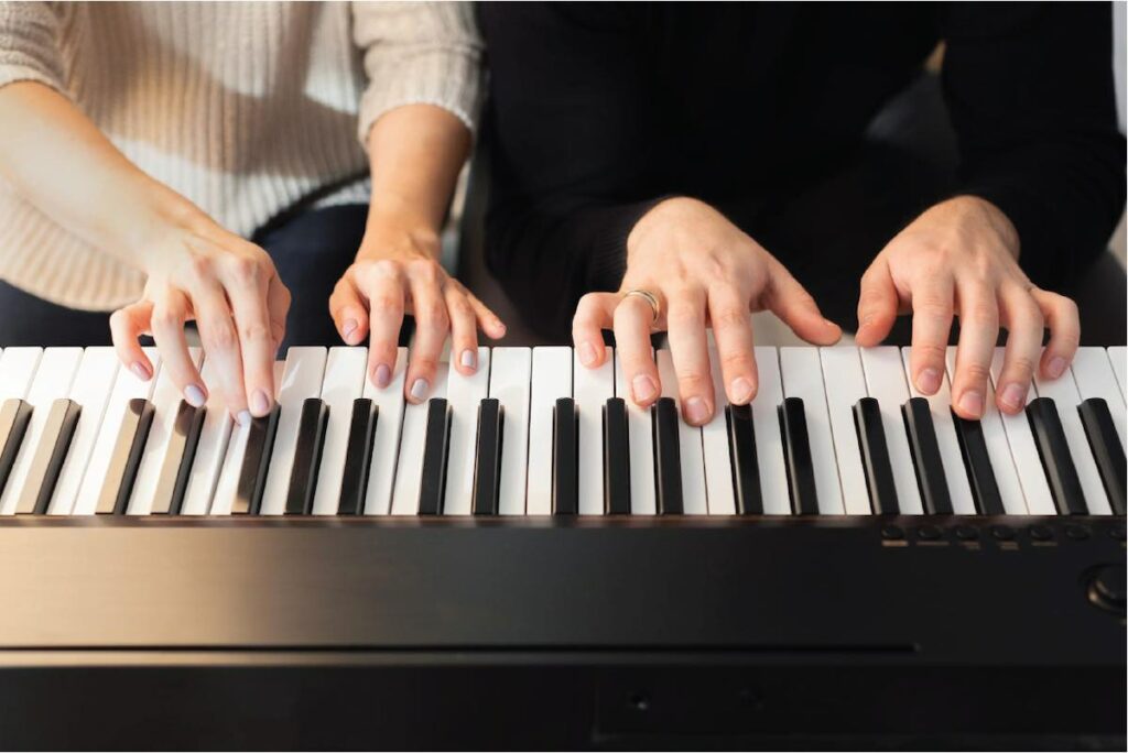 two-people-playing-piano
